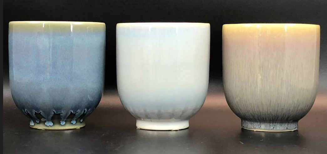 Three ombré spray-glaze ceramic vessels