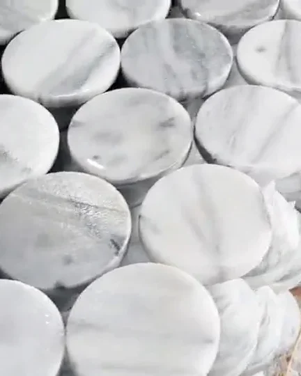 Stacked Hualien marble discs with natural grey veining