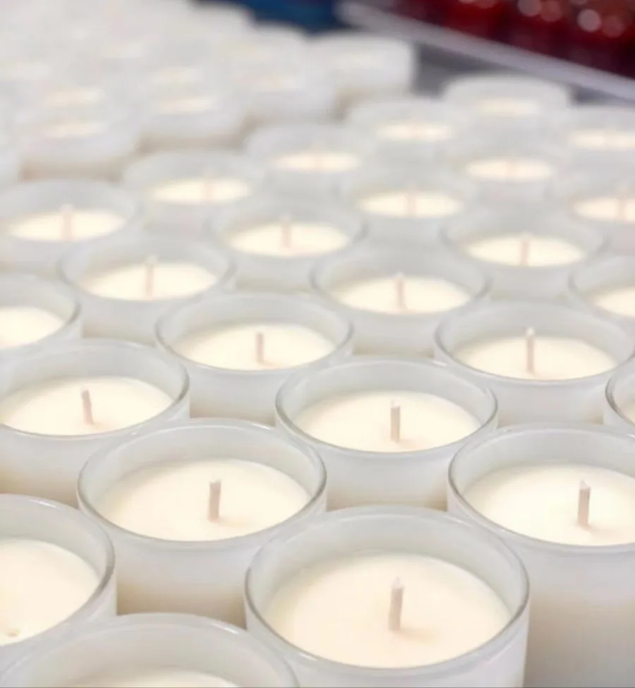 Finished candles in frosted glass vessels