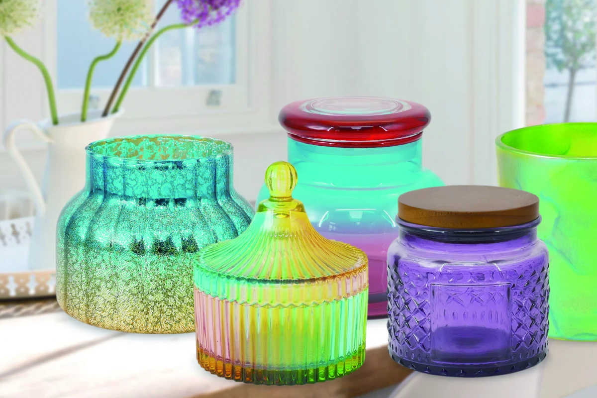 Mercury, ribbed, lidded and embossed glass candle vessels in a sunlit room