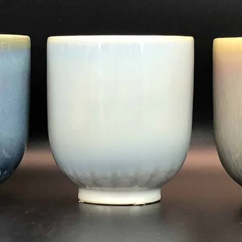 Three ceramic tumblers in reactive glaze colorways