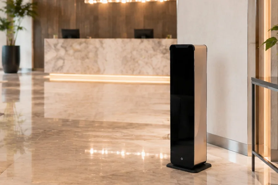 Floor-standing waterless scent diffuser beside a hotel reception desk