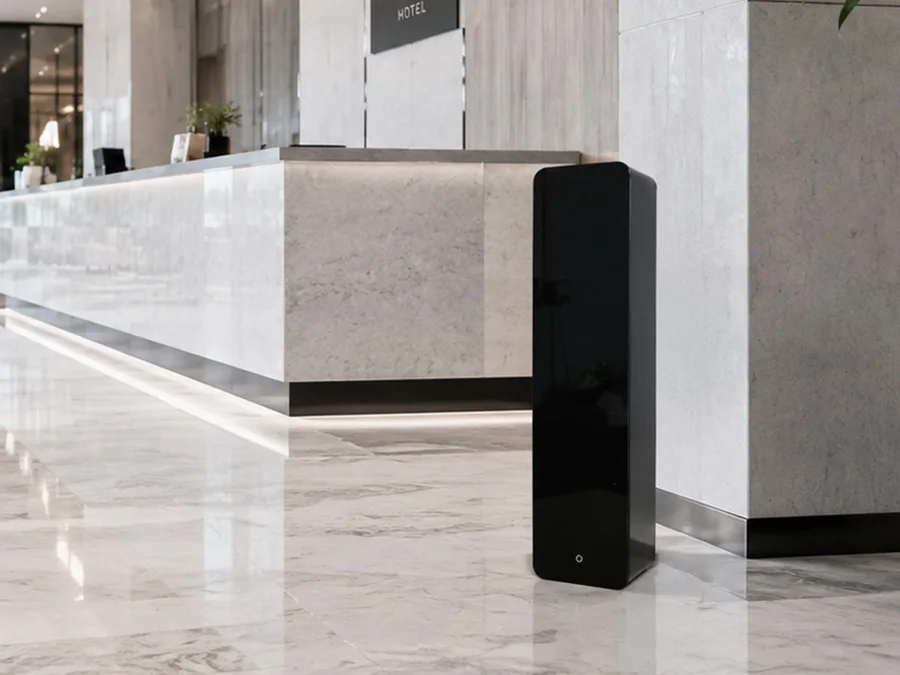 Black floor scent diffuser beside a reception counter