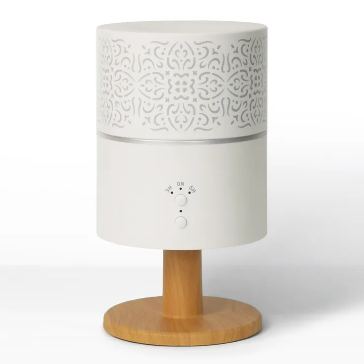Lamp-style diffuser with a pierced white shade on a turned wood stand