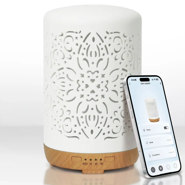 Ceramic smart diffuser beside a phone showing its control app