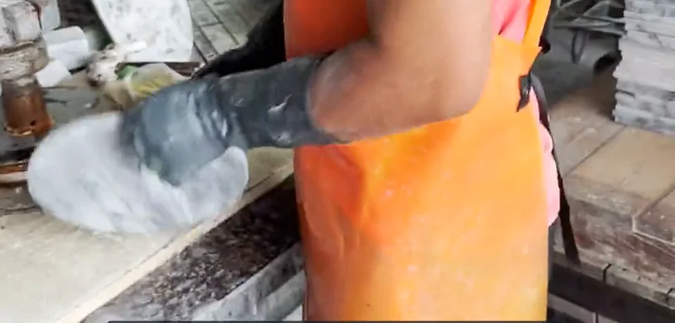 Hand polishing a round marble piece