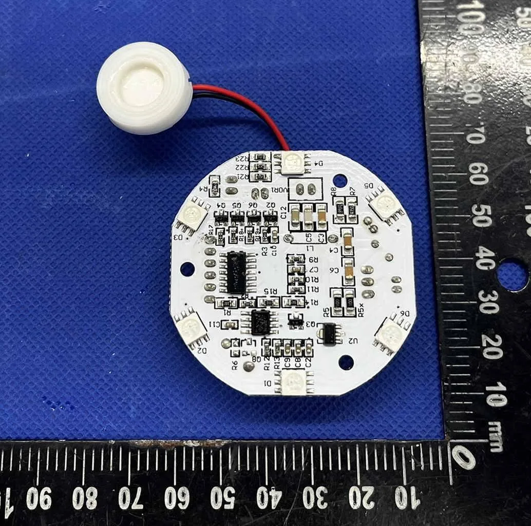 Circuit board and atomizer disc on an inspection mat