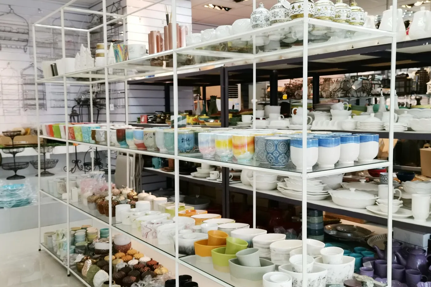Our showroom shelves of glazed ceramic dinnerware, bowls and mugs