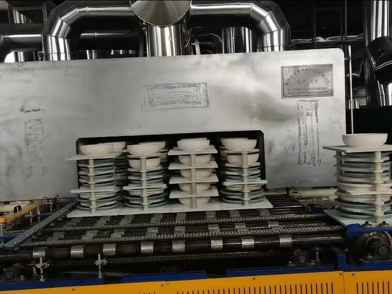 Ceramic plates stacked on a kiln car at a tunnel kiln