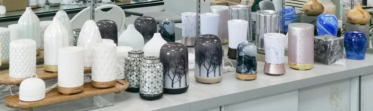 Rows of ultrasonic diffuser samples in ceramic, printed glass, metal and wood-grain finishes in our Shenzhen showroom