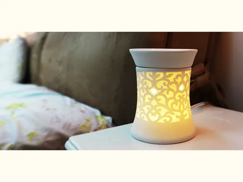 Pierced ceramic wax warmer lit from inside
