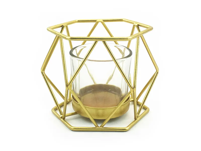 Geometric gold metal frame holding a glass candle cup